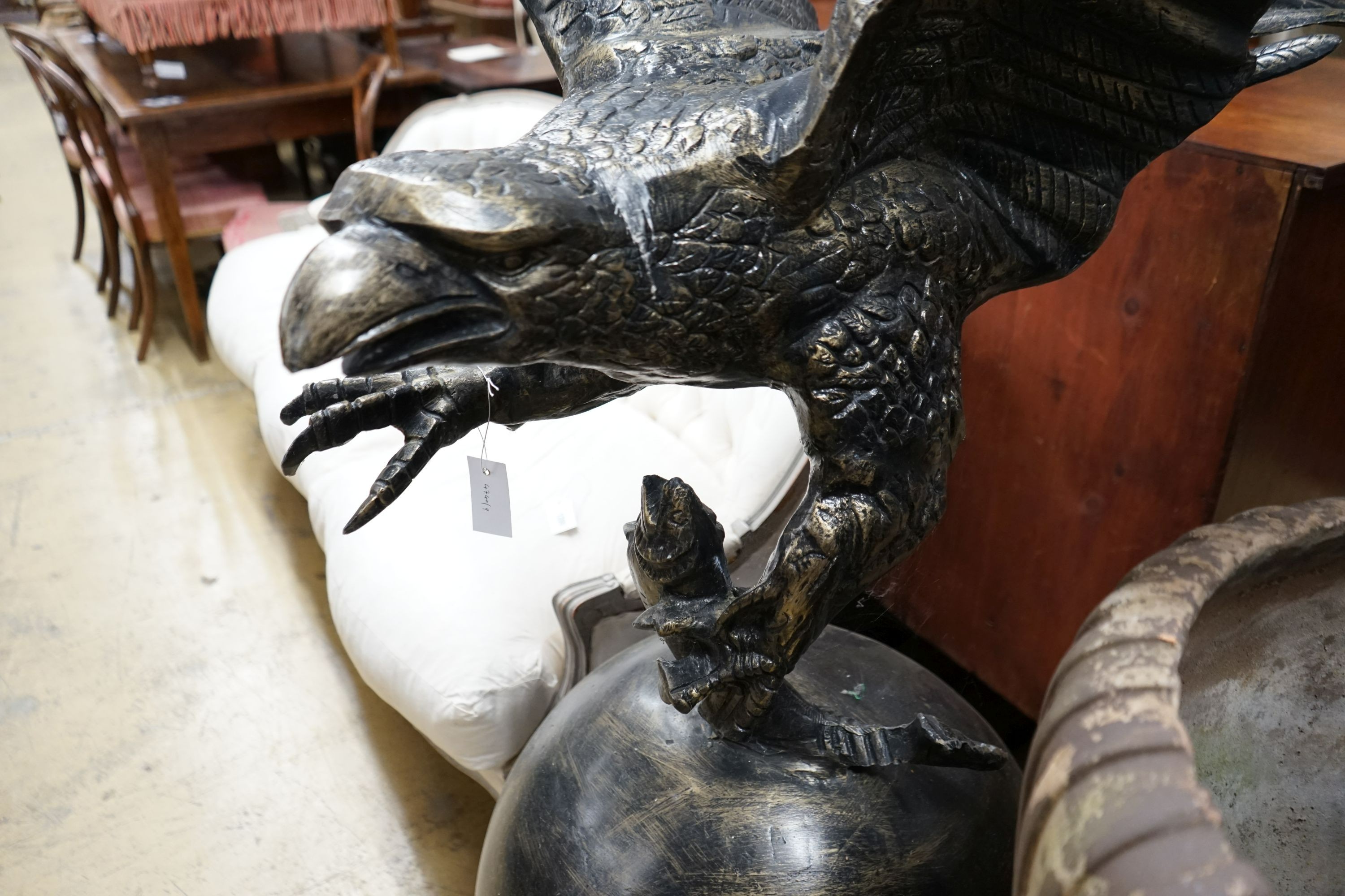 A large cast metal faux bronze eagle, salmon and orb garden ornament, height 200cm